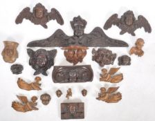 LARGE COLLECTION OF CARVED FIGURE HEADS AND WALL MASKS