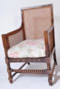 1920'S OAK & CANE WORED BERGERE ARMCHAIR