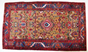 A vintage late 20th century Persian Islamic Hamadan floor carpet rug in vibrant tones with a