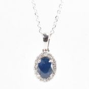 18CT WHITE GOLD SAPPHIRE & DIAMOND HALO PENDANT & CHAIN