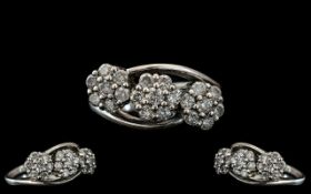 Ladies 18ct White Gold Attractive Triple Cluster Diamond Set Ring, the diamonds being well matched,
