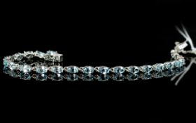 Sky Blue Topaz Tennis Bracelet, an articulated line of oval cut, sparkling, sky blue topaz,