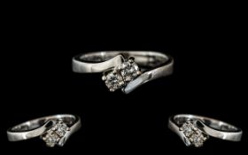 An 18ct Two Stone Diamond Cross-over rin