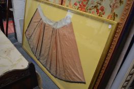 A Chinese silk and embroidered skirt mounted in a large glazed display case.