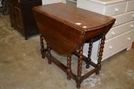 An oak drop leaf gate leg dining table.