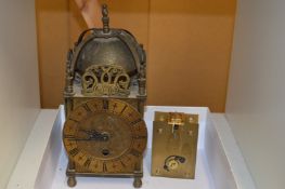 A reproduction brass lantern clock with quartz movement (original movement included).