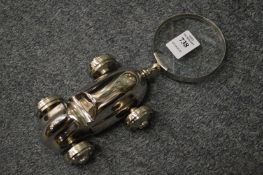 A magnifying glass with car shaped handle.