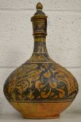 An Islamic painted terracotta bottle.