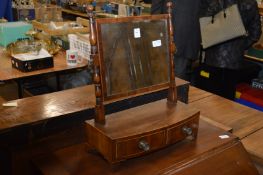 A mahogany dressing table mirror with two drawers to the bow fronted base.