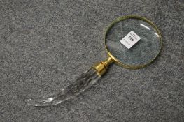 A magnifying glass with cut glass handle.
