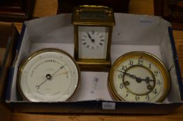 A brass carriage clock, a small circular clock and barometer.