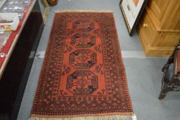 A Persian rug, red ground with four large medallions.