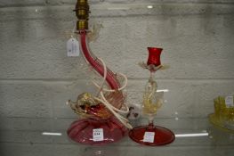 A Murano glass dolphin lamp and similar candlestick.
