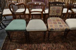 Three mahogany dining chairs.