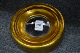 A small gilt framed convex mirror.
