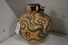 A museum copy of an unusual pottery vase decorated with octopus.
