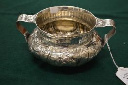A good silver circular embossed twin handled sugar bowl, London 1890.