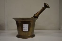 An old brass pestle and mortar.