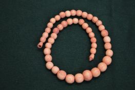 A stained ivory bead necklace.