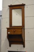 An oak hall mirror with small drawer.