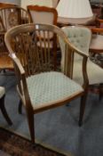 An Edwardian mahogany and inlaid elbow chair.