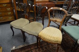 A pair of Victorian mahogany dining chairs and another chair.