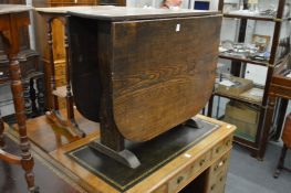 An old drop leaf gate leg dining table.
