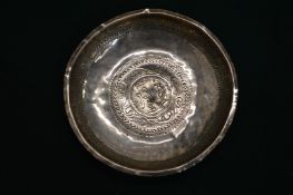 A Chinese engraved white metal dish.