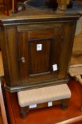 A small oak hanging corner cupboard, a stool, a stationery tray and a magazine rack.