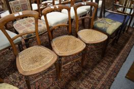 Three cane seated chairs.