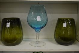 A pair of moulded green glass vases and a large brandy goblet.
