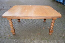 An early 20th century Indian rosewood extending dining table with one leaf, on barley twist legs.