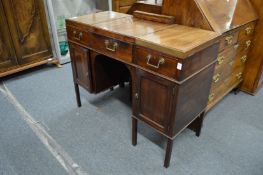 A George III mahogany dressing table with bi-fold top, rising mirror and cupboards to the base.