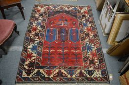 A Persian style carpet, red ground with geometric design.