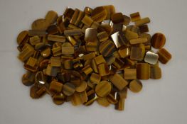 A box of unmounted tiger's eye.