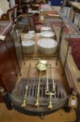 A brass companion set, a spark guard and fire grate.
