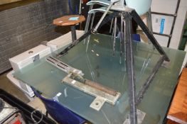 A clay pigeon trap and two boxes of clays.