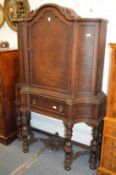 A continental stained walnut cupboard on stand.