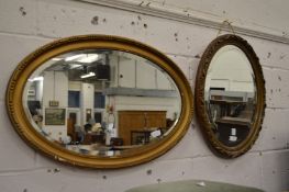 Two oval gilt framed mirrors.