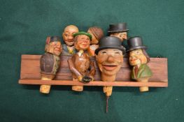 Amusing carved wood bottle stoppers.