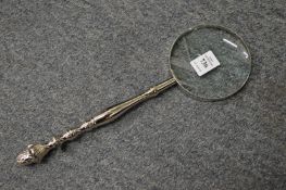 A magnifying glass with plated handle.