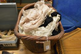 A basket containing a quantity of lace trimmings etc.
