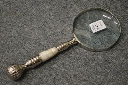 A magnifying glass with mother-of-pearl handle.