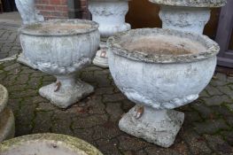 A pair of pedestal garden planters.