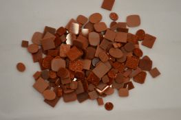 A box of unmounted goldstone.