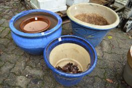 Four large glazed garden planters.