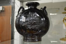 A large brown glazed pottery ewer.