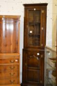 A good small oak standing corner cabinet in two parts.