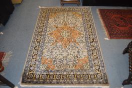 A Persian rug, beige ground with floral decoration.