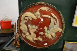 A Chinese circular lacquer and onlaid picture depicting fighting dragons and cockerels.